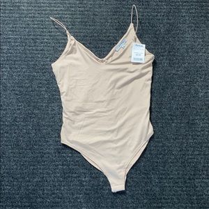 Tan bodysuit.
